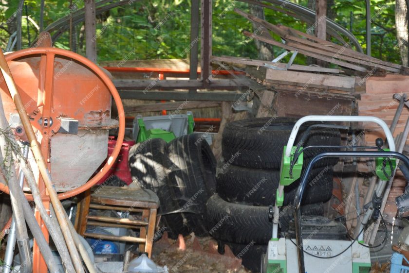 messy yard with dusty old equipment old tires