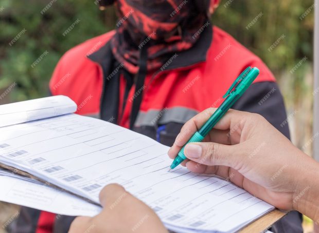 delivery-service-female-hands-holding-pen-signing-delivery-document_42667-1952
